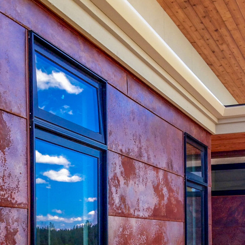 Image of rusted copper siding with flush window detail.