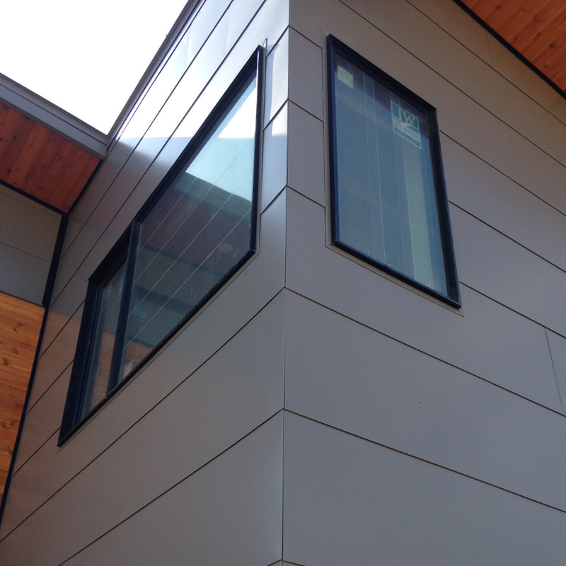 Image of metal siding and window detail manufactured by River Roofing-Bend.