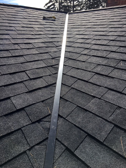 Heat tape installation on shingled roof.